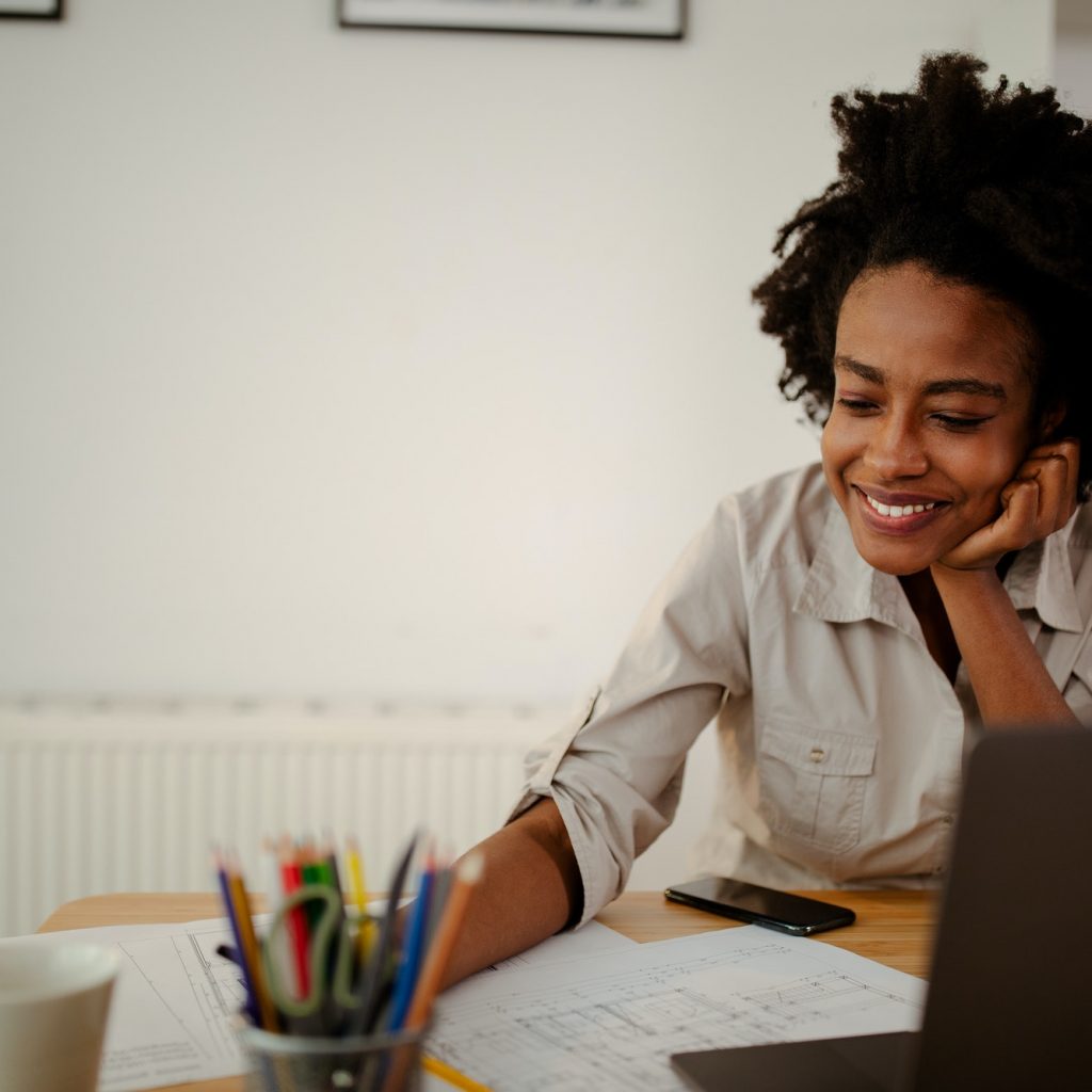 The young black female architect working on project, with smile and happy face.